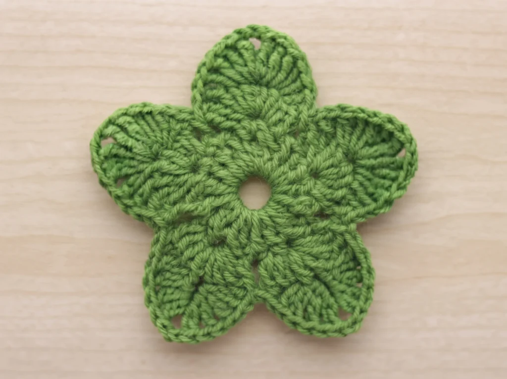 Crochet rose finished 5-point green sepal, laid flat