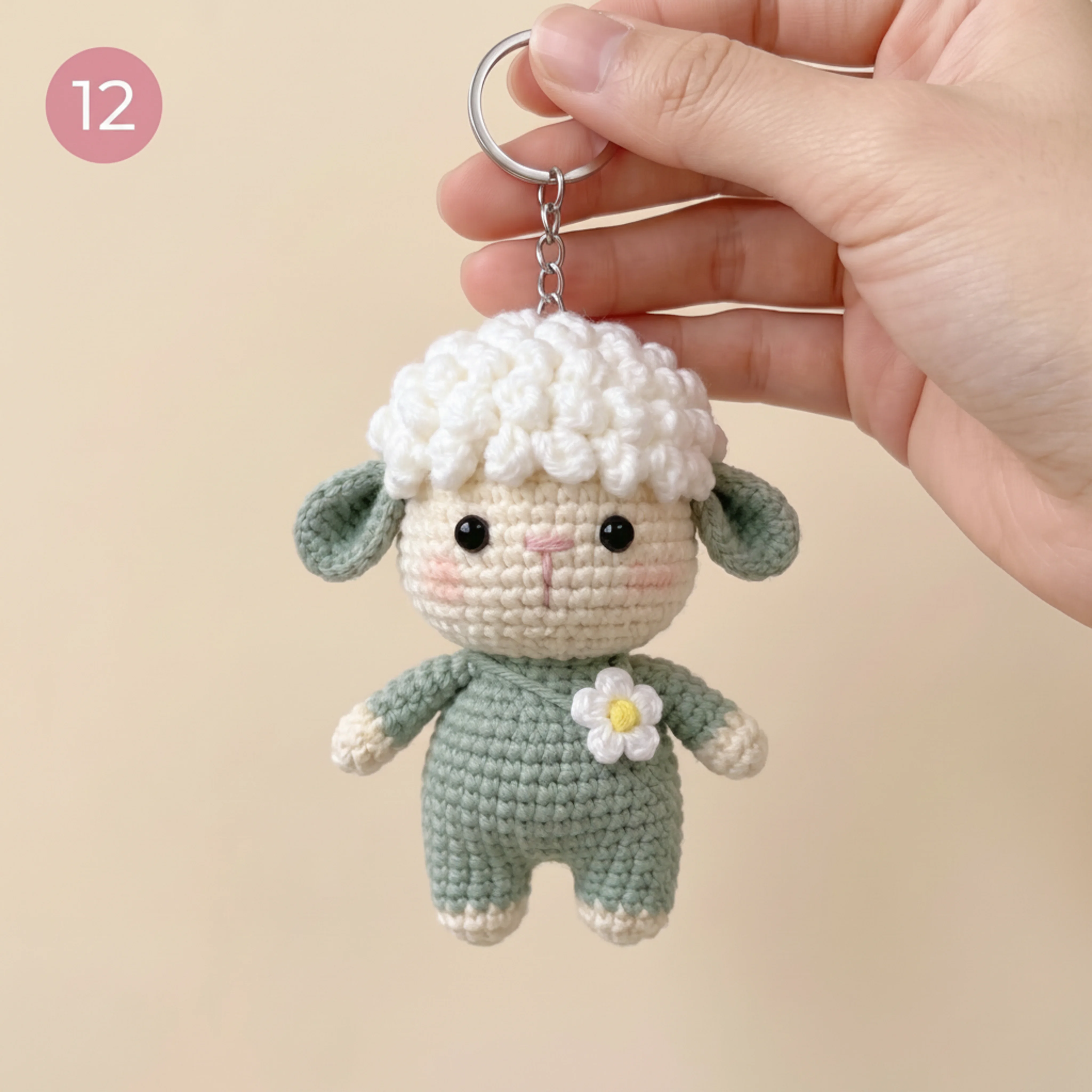 The finished crochet lamb keychain held on its keyring for scale