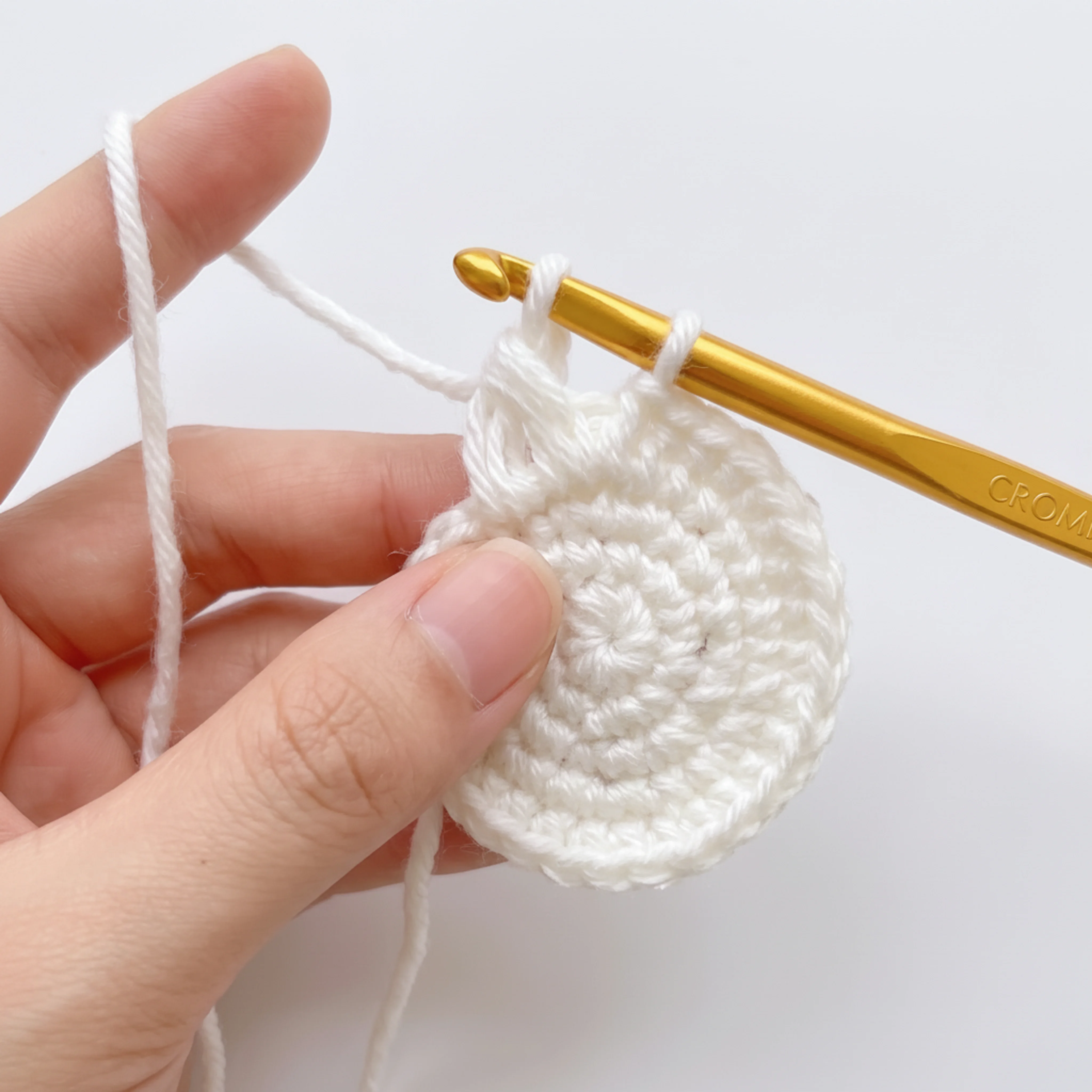 Close-up of the loop stitch technique used for the crochet lamb keychain wool cap