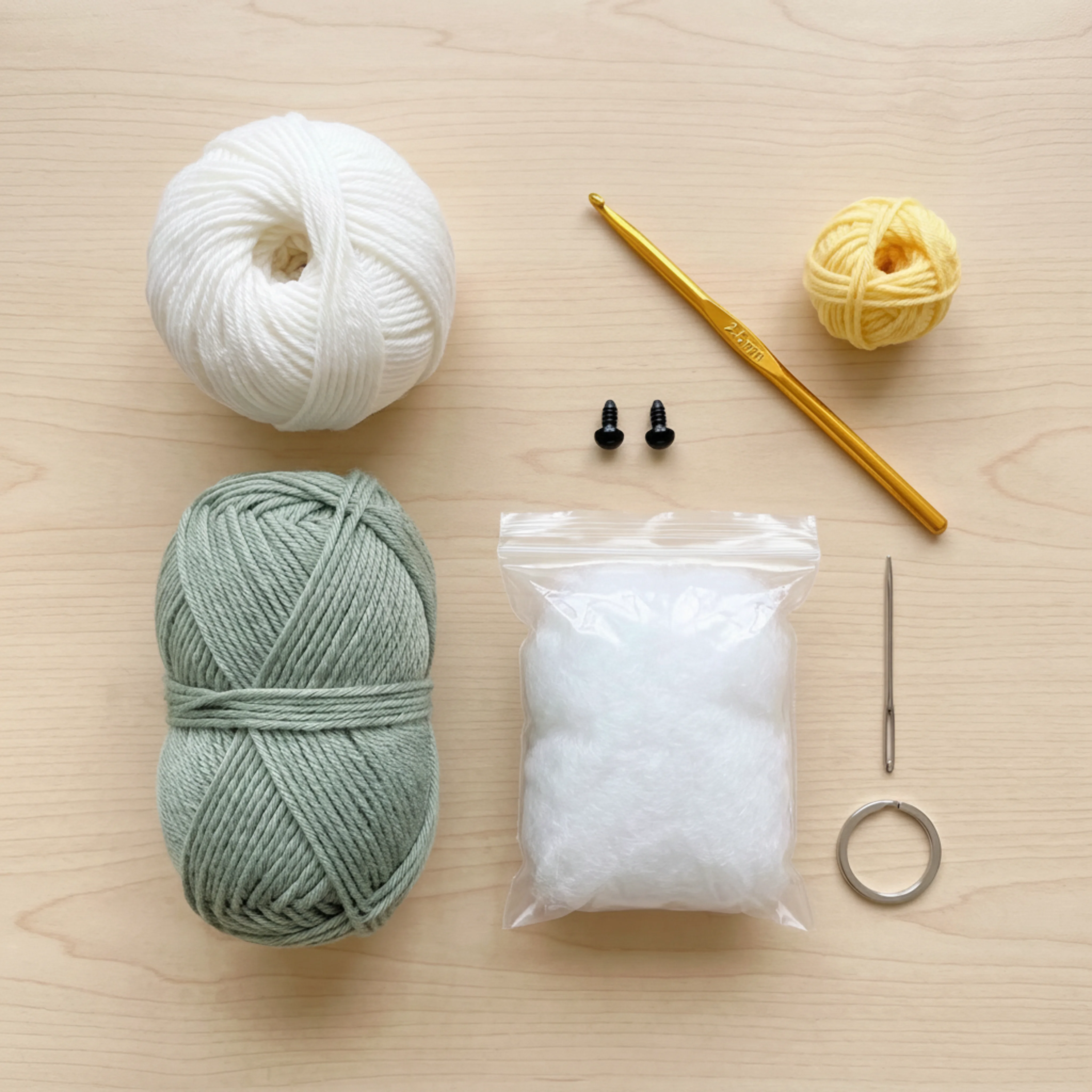 Materials for the crochet lamb keychain: yarn, hook, safety eyes, stuffing, and keyring