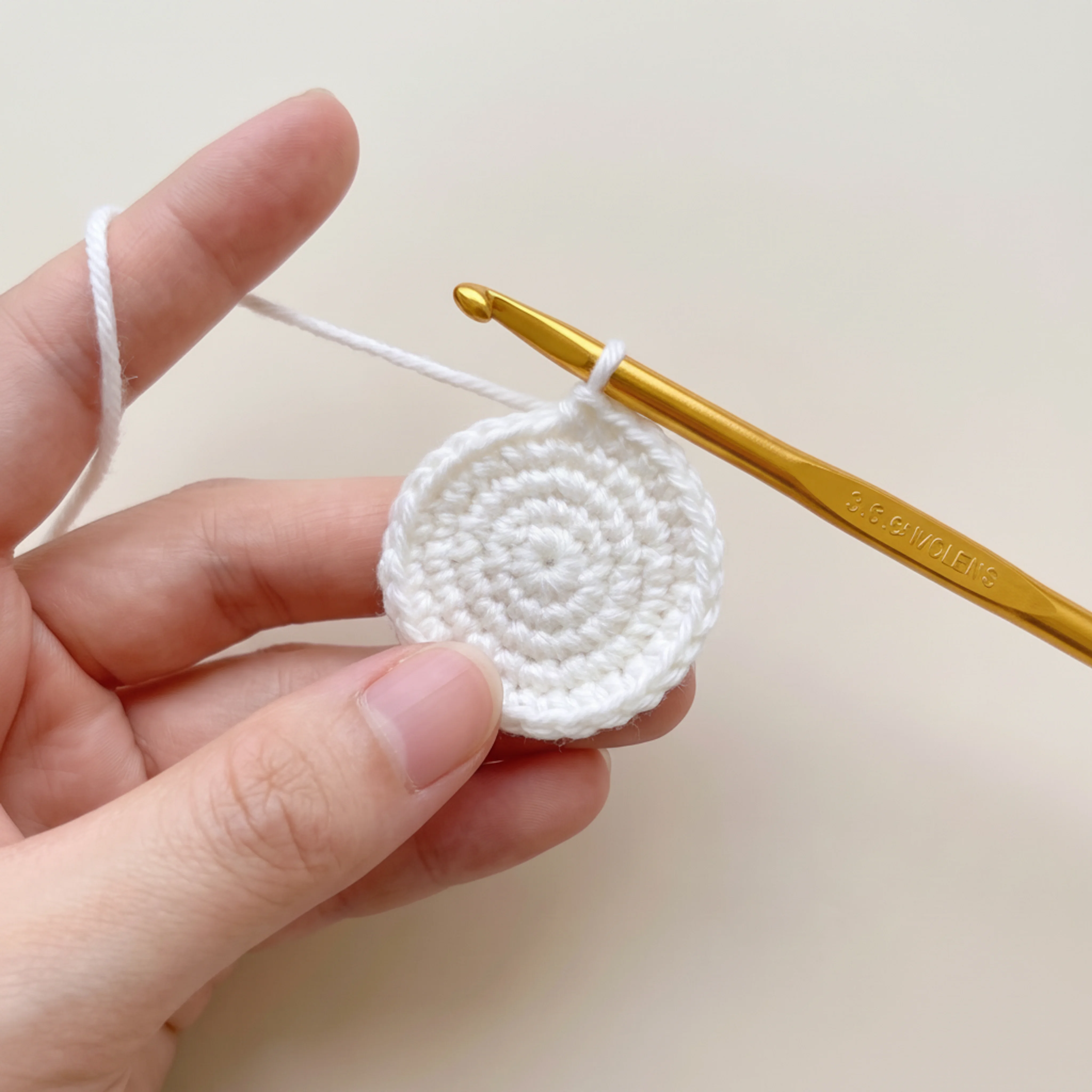 Beginning the loop stitch rounds for the crochet lamb keychain wool cap