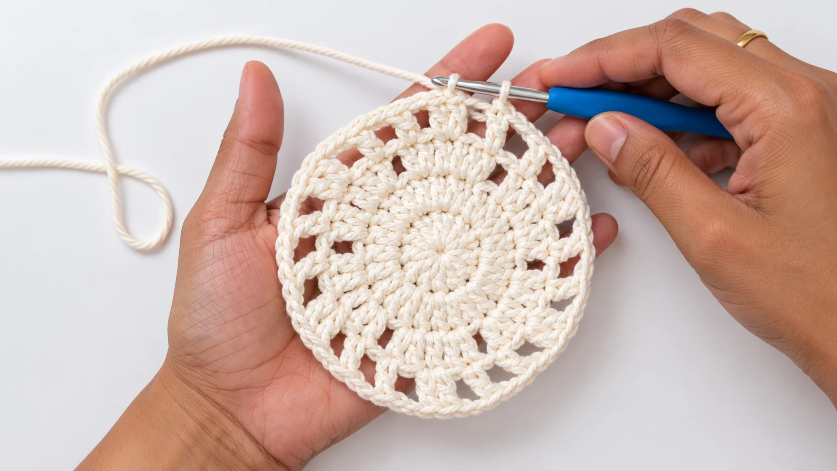 Close-up of an ivory crochet mandala stitch pattern used in a maple leaf crochet coaster